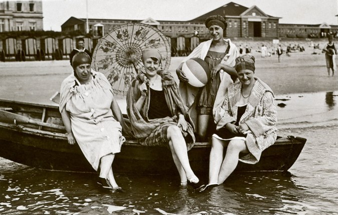 Historisches Foto von vier Damen auf einem Boot am Strand auf Norderney